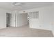 Bright living room with neutral carpet, ceiling fan and access to other rooms at 1515 N Saguaro Dr, Tempe, AZ 85288