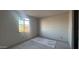 Bright bedroom featuring smooth concrete floors and neutral walls, providing ample space and natural light at 15785 W Beryl Ave, Waddell, AZ 85355