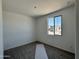 Bright bedroom features a window with a view and neutral carpeting, ready for personalization at 15785 W Beryl Ave, Waddell, AZ 85355