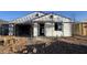 New construction featuring modern design and quality materials showcasing its contemporary charm at 15785 W Beryl Ave, Waddell, AZ 85355