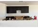 This kitchen features dark cabinetry, hardware, and a white countertop area at 15785 W Beryl Ave, Waddell, AZ 85355