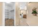 Bathroom showcasing dual sinks, a soaking tub, and walk-in closet at 1623 E Leaf Rd, San Tan Valley, AZ 85140