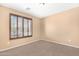 Cozy carpeted bedroom enhanced by natural light streaming through window with privacy blinds at 1623 E Leaf Rd, San Tan Valley, AZ 85140