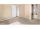 Carpeted bedroom with a well-organized closet featuring an adjustable shelving system and shuttered window at 1623 E Leaf Rd, San Tan Valley, AZ 85140