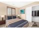 Relaxing bedroom boasts neutral tones, an en-suite bathroom, and a spacious closet at 1623 E Leaf Rd, San Tan Valley, AZ 85140