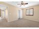 Inviting bedroom with soft carpeting, a ceiling fan, and closet across from the view of a hallway at 1623 E Leaf Rd, San Tan Valley, AZ 85140