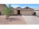 Inviting home featuring a well-kept front yard, desert landscaping, and attached two-car garage at 1623 E Leaf Rd, San Tan Valley, AZ 85140