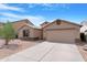 Attractive home featuring a well-kept front yard, desert landscaping, and attached two-car garage at 1623 E Leaf Rd, San Tan Valley, AZ 85140