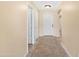 Hallway boasts neutral walls and tiled flooring accented by decorative tile border at 1623 E Leaf Rd, San Tan Valley, AZ 85140
