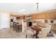 Bright kitchen features stainless steel appliances, counter seating, and a cozy dining area with wood table at 1623 E Leaf Rd, San Tan Valley, AZ 85140