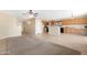Spacious kitchen flows into the living area, featuring wooden cabinets and modern appliances at 1623 E Leaf Rd, San Tan Valley, AZ 85140