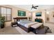 Comfortable main bedroom featuring a ceiling fan, an en-suite bathroom, and neutral decor at 1623 E Leaf Rd, San Tan Valley, AZ 85140