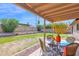 Backyard with covered patio, block fencing, gravel and garden bed at 16421 N 65Th Pl, Scottsdale, AZ 85254
