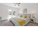 Bright bedroom with neutral carpet, ceiling fan, and patio doors leading to the backyard at 16421 N 65Th Pl, Scottsdale, AZ 85254