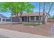 Charming single-story home featuring desert landscaping, mature trees, and neutral tones at 16421 N 65Th Pl, Scottsdale, AZ 85254