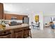 Open kitchen with granite counters, stainless appliances, and breakfast bar seating at 16421 N 65Th Pl, Scottsdale, AZ 85254