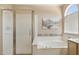 A bright bathroom includes a separate shower and soaking tub and decorative accent tiles at 17141 E Rockwood Dr, Fountain Hills, AZ 85268