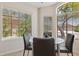 A dining area boasts ample natural light with large windows offering serene views of the surrounding landscape at 17141 E Rockwood Dr, Fountain Hills, AZ 85268