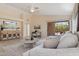 Open-concept living room featuring a large sectional, entertainment center, and access to the outdoor patio at 17141 E Rockwood Dr, Fountain Hills, AZ 85268
