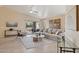 Bright living room with a large sectional couch, decorative rug, and sliding glass doors to an outdoor space at 17141 E Rockwood Dr, Fountain Hills, AZ 85268