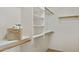 A walk-in closet features wooden rails and multiple shelves perfect for organized storage at 17141 E Rockwood Dr, Fountain Hills, AZ 85268