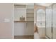 Walk-in closet offers built-in shelves and ample storage with access to the ensuite bathroom at 17141 E Rockwood Dr, Fountain Hills, AZ 85268