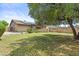 Expansive backyard featuring lush lawn, mature trees, privacy wall, and solar panels on home at 17244 N 29Th Ave, Phoenix, AZ 85053