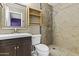 Nicely tiled bathroom with a sink, vanity, shower, and storage shelves at 17244 N 29Th Ave, Phoenix, AZ 85053