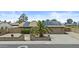 Charming home with solar panels, a two-car garage, desert landscaping, and privacy wall with mature plants at 17244 N 29Th Ave, Phoenix, AZ 85053