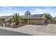 Charming home featuring solar panels, a two-car garage, and a lovely front yard with a palm tree at 17244 N 29Th Ave, Phoenix, AZ 85053