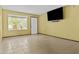 Bright living room with tiled floors, a large window offering ample natural light, and a mounted television at 17244 N 29Th Ave, Phoenix, AZ 85053