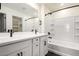 Well-lit bathroom with double sinks, tile backsplash, and a shower-tub combo for a relaxing experience at 1762 E Elegante Dr, Casa Grande, AZ 85122