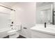 Modern bathroom features a white vanity, black hardware, and a shower over tub at 1762 E Elegante Dr, Casa Grande, AZ 85122