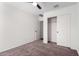Bright bedroom features neutral carpeting, a ceiling fan, closet, and an en-suite bathroom at 1762 E Elegante Dr, Casa Grande, AZ 85122