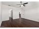 Spacious bedroom with hardwood flooring, a ceiling fan, and access to the bathroom and kitchen at 1762 E Elegante Dr, Casa Grande, AZ 85122
