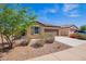 Well maintained single-story home with low maintenance landscaping, blue sky and flowering bushes at 1762 E Elegante Dr, Casa Grande, AZ 85122