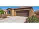 Well maintained single-story home with low maintenance landscaping, driveway, ADT security and flowering bushes at 1762 E Elegante Dr, Casa Grande, AZ 85122