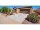 Well maintained single-story home with low maintenance landscaping, blue sky, driveway and flowering bushes at 1762 E Elegante Dr, Casa Grande, AZ 85122