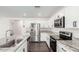 Beautiful kitchen features white cabinets, granite counters, stainless steel appliances, and island with a sink at 1762 E Elegante Dr, Casa Grande, AZ 85122