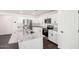 Modern kitchen with white cabinets, stainless steel appliances, granite countertops, and center island with sink at 1762 E Elegante Dr, Casa Grande, AZ 85122