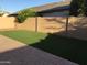 Private backyard with a block fence, patio, and low-maintenance artificial grass at 1827 E Carla Vista Dr, Gilbert, AZ 85295