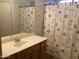 Bathroom featuring a vanity with a sink and a shower-tub combo at 1827 E Carla Vista Dr, Gilbert, AZ 85295