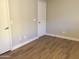 Neutral bedroom with wood-look flooring and white baseboards at 1827 E Carla Vista Dr, Gilbert, AZ 85295