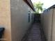Home exterior showcasing a private walkway leading to a gated entrance at 1827 E Carla Vista Dr, Gilbert, AZ 85295