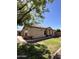 This exterior shows a well manicured lawn and desert landscaping with a brick accent and tile roof at 1827 E Carla Vista Dr, Gilbert, AZ 85295