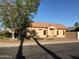 Charming single-story home with a well-maintained lawn and mature trees in a sunny neighborhood at 1827 E Carla Vista Dr, Gilbert, AZ 85295