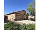 Exterior shot of a single-story home showcasing the garage and desert landscaping at 1827 E Carla Vista Dr, Gilbert, AZ 85295