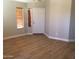 Bright living room with modern flooring, neutral walls, and a welcoming front door entrance at 1827 E Carla Vista Dr, Gilbert, AZ 85295