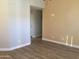 Inviting living room featuring wood-look flooring and neutral paint, providing a blank canvas for personalization at 1827 E Carla Vista Dr, Gilbert, AZ 85295
