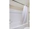 Clean white tiled bathroom with a shower and tub at 1880 E Morten Ave # 125, Phoenix, AZ 85020